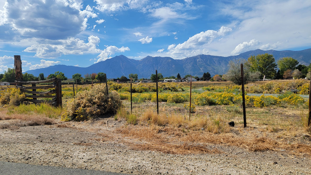 Beautiful mountains with clouds hovering over dessert land.